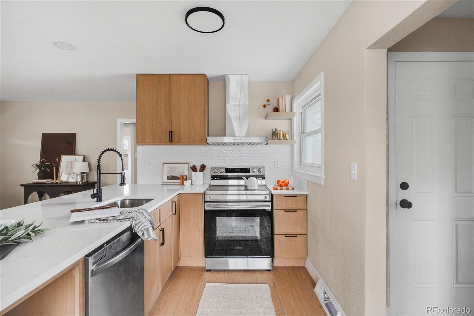1900 Quebec Street Denver, CO 80220 - Photo 3 of 15 a kitchen with a sink stove and refrigerator