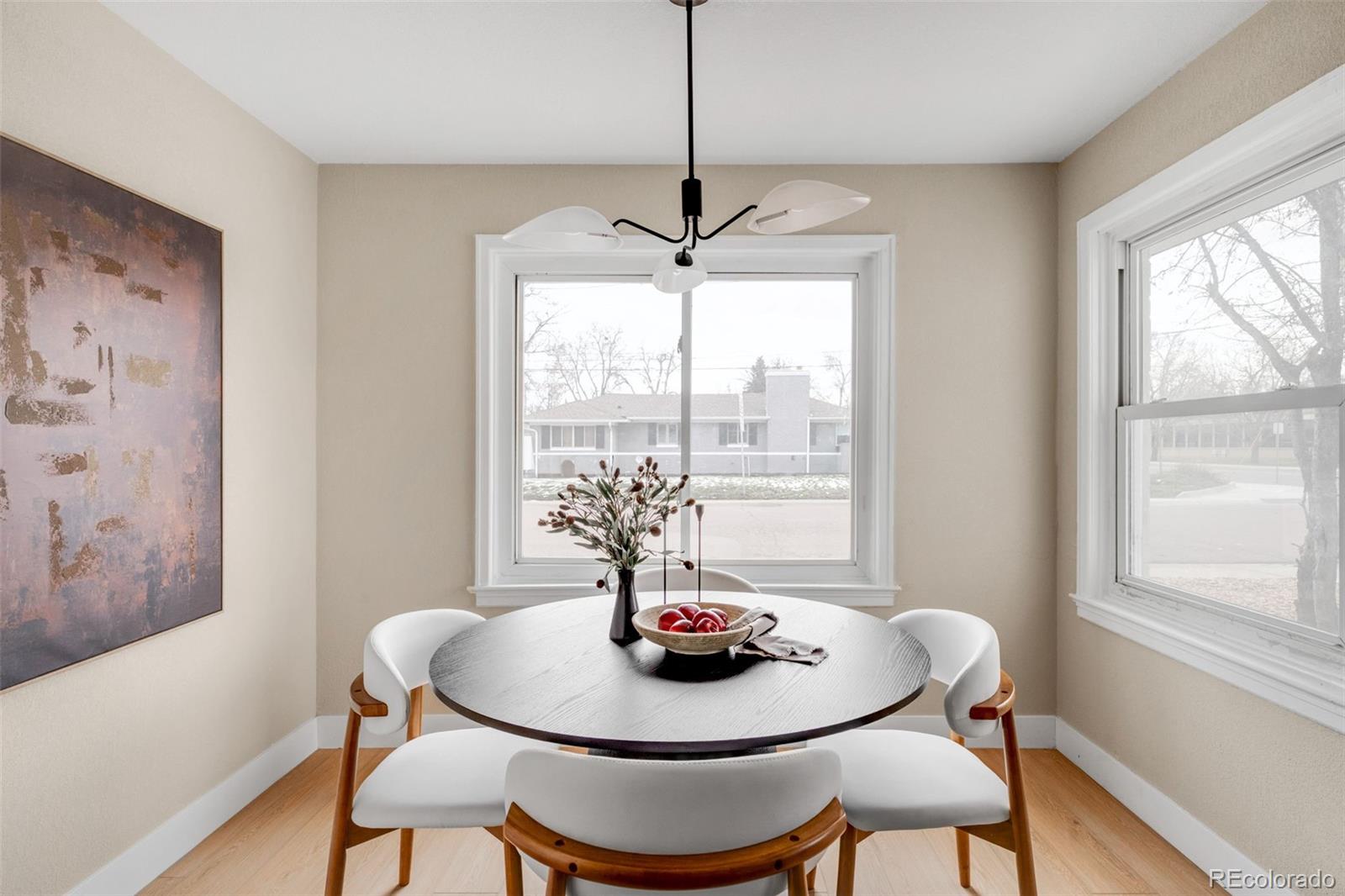 1900 Quebec Street Denver, CO 80220 - Photo 4 of 15 a dining room with furniture a rug and a large window
