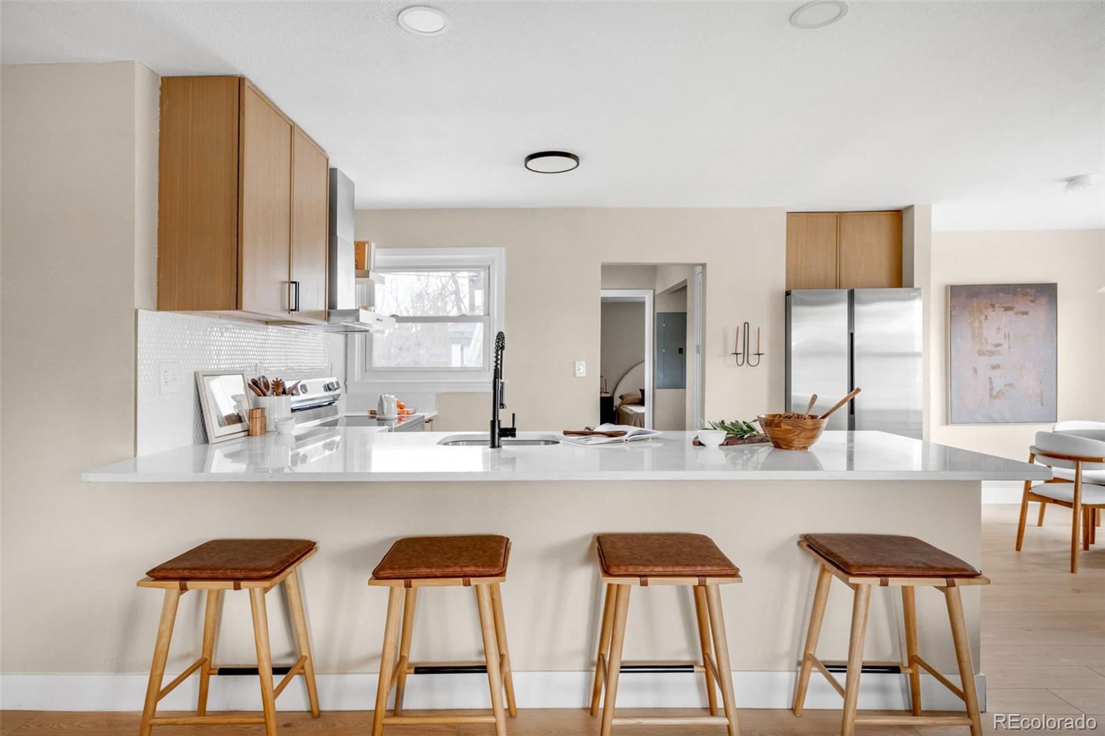 1900 Quebec Street Denver, CO 80220 - Photo 5 of 15 a kitchen with stainless steel appliances a table and chairs in it