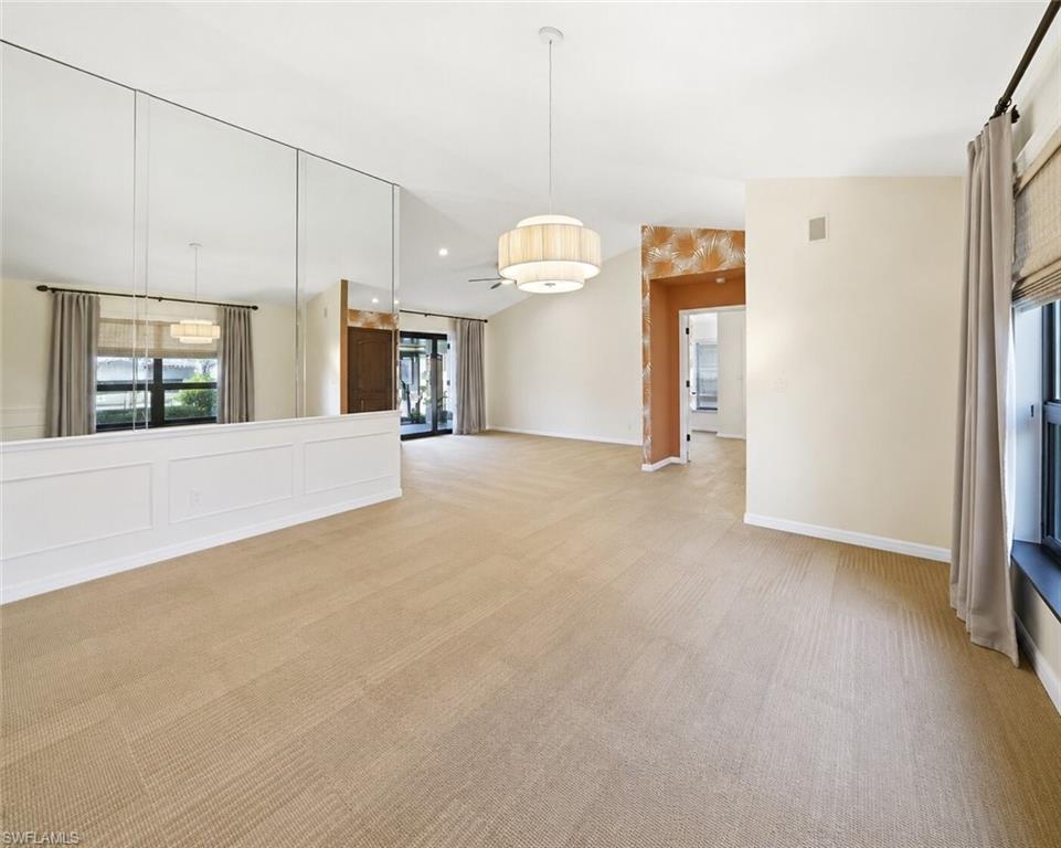 2274 Queens Way Naples, FL 34112 - Photo 12 of 28 a view of a kitchen with an empty room and windows