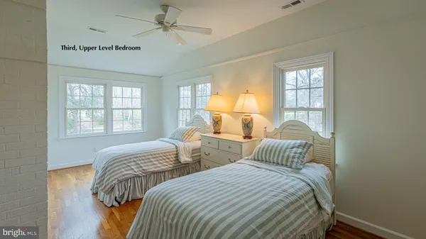 a bedroom with two beds and a window