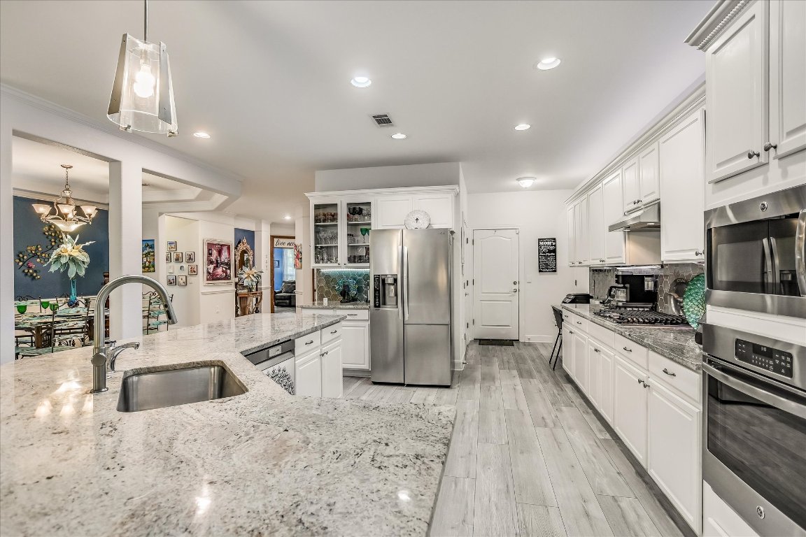 902 Rio Grande Loop Georgetown, TX 78633 - Photo 14 of 29 a kitchen with stainless steel appliances granite countertop a refrigerator sink and cabinets