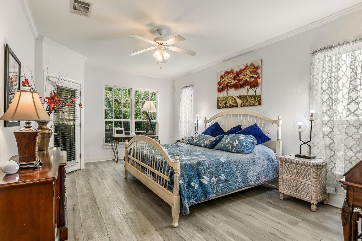 902 Rio Grande Loop Georgetown, TX 78633 - Photo 16 of 29 a bedroom with a bed and a chandelier