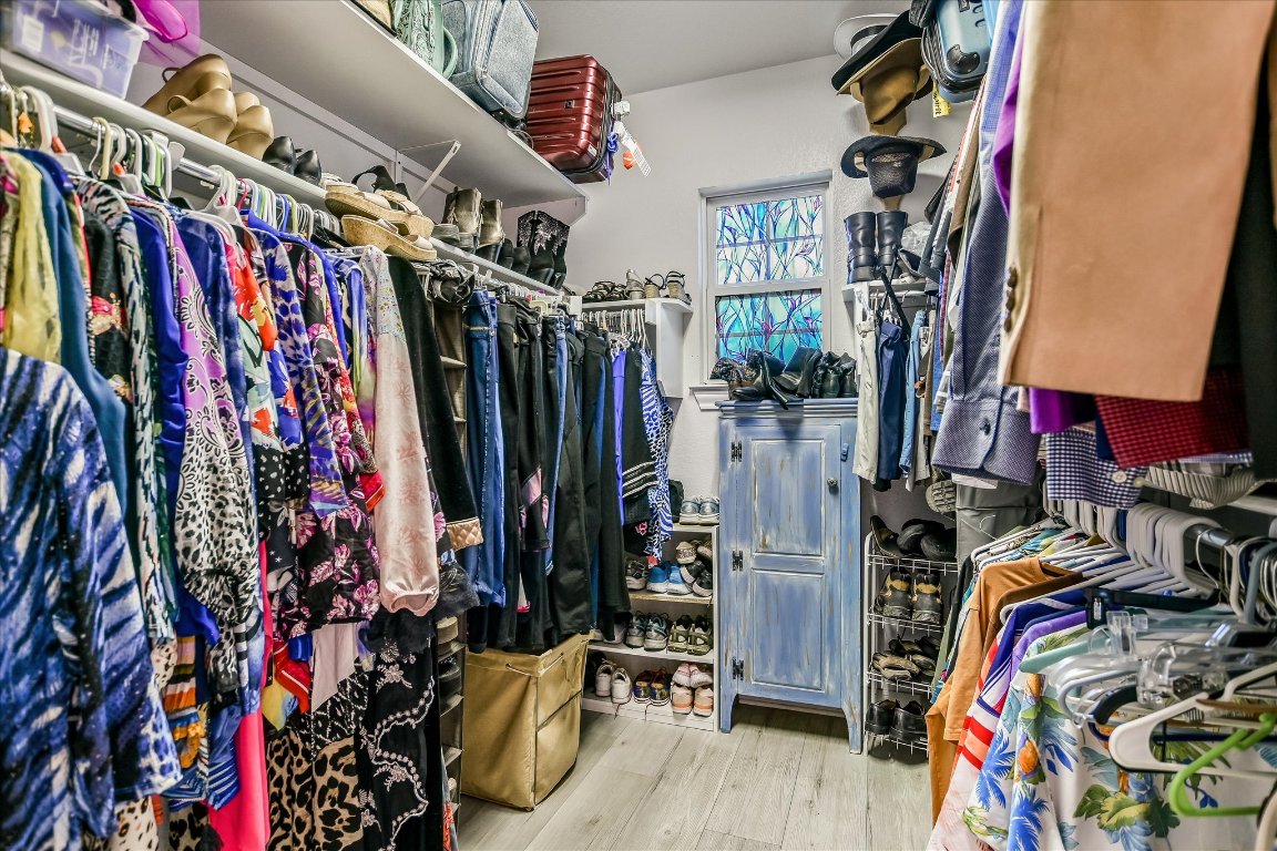 902 Rio Grande Loop Georgetown, TX 78633 - Photo 17 of 29 a view of walk in closet with clothes