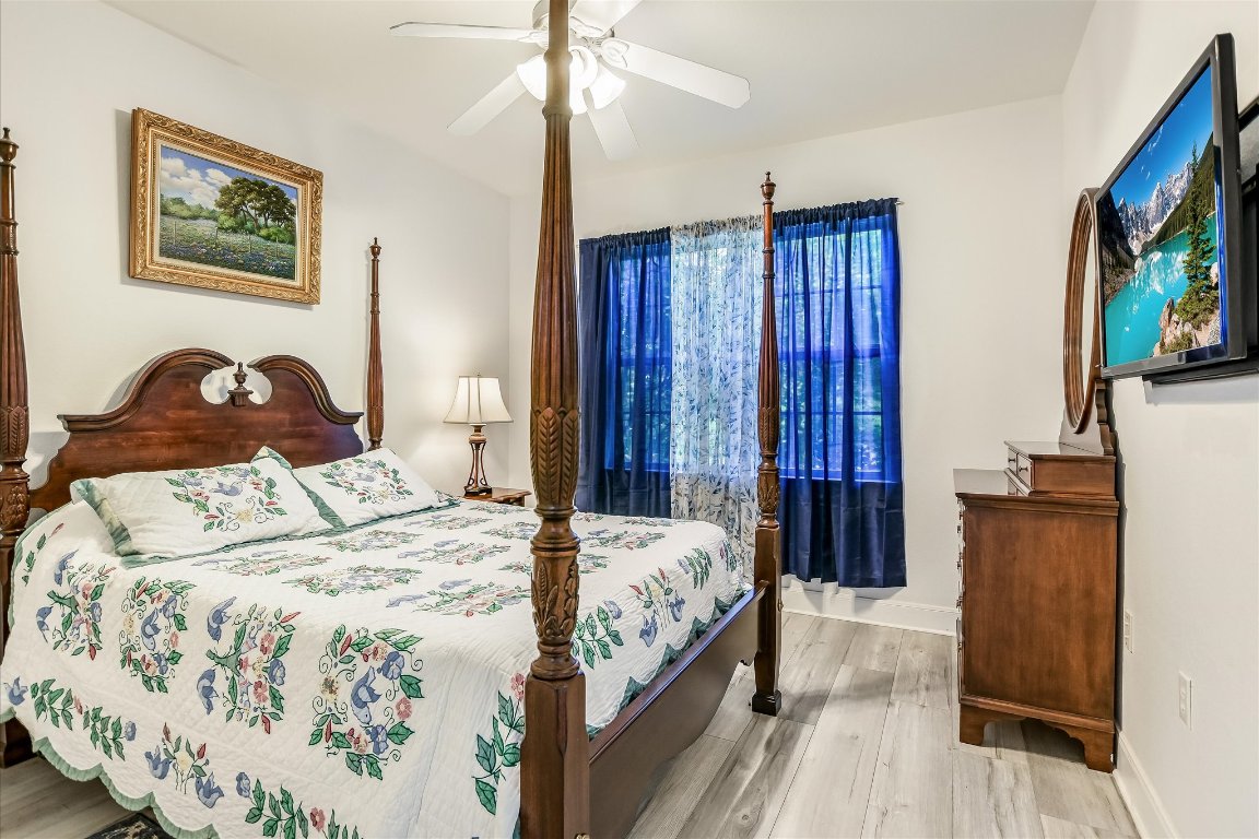 902 Rio Grande Loop Georgetown, TX 78633 - Photo 19 of 29 a bedroom with a bed and a flat screen tv