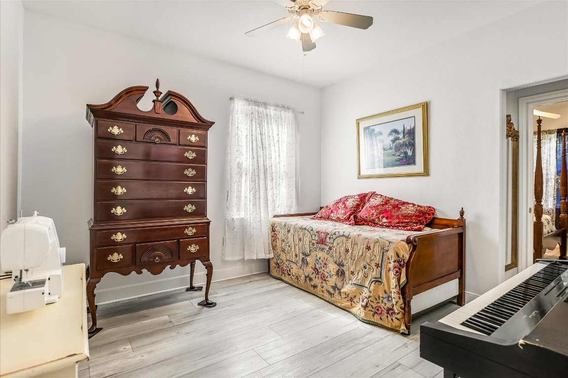 902 Rio Grande Loop Georgetown, TX 78633 - Photo 21 of 29 a bedroom with a bed and wooden floor