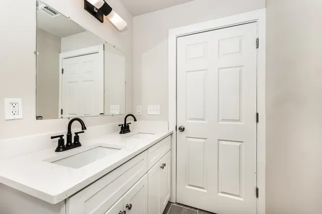 a bathroom with a sink and mirror