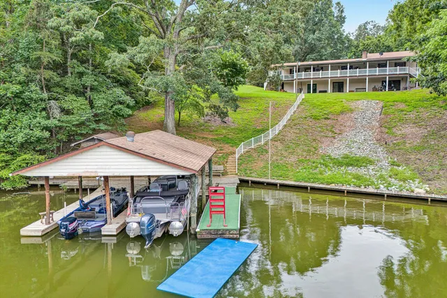 a aerial view of a house with swimming pool and a yard