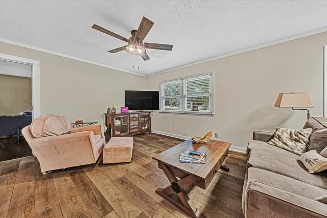 a living room with furniture and a chandelier