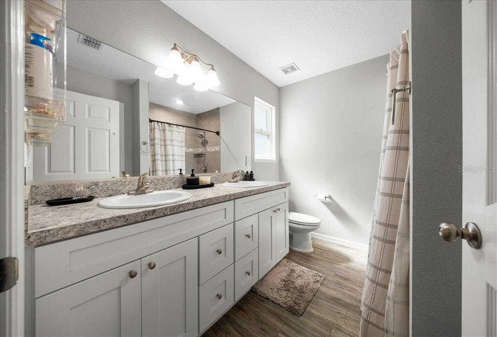 13 Teak Loop Place Ocala, FL 34472 - Photo 31 of 36 a bathroom with a double vanity sink and a toilet