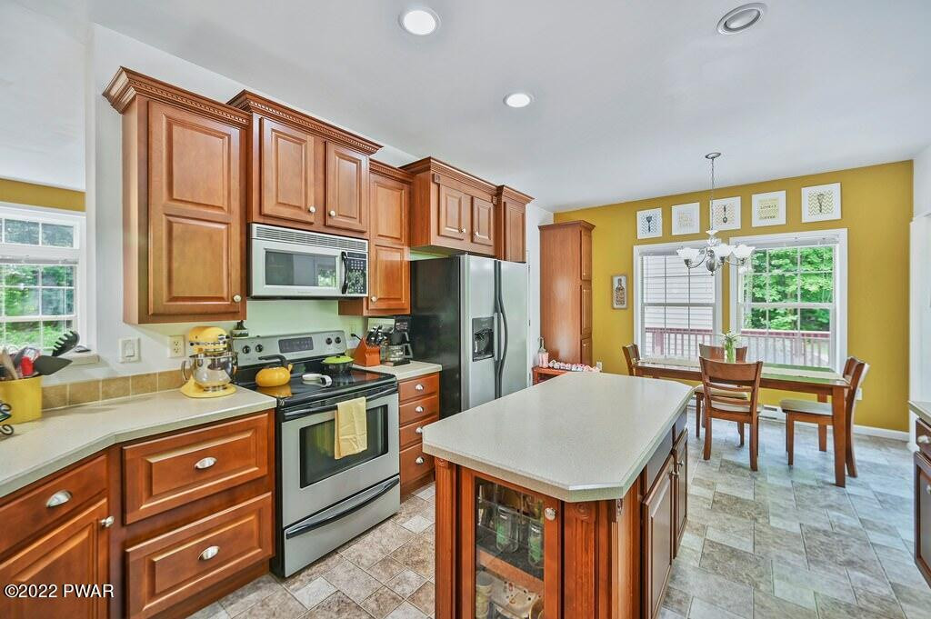 131 Anderson Road Lake Ariel, PA 18436 - Photo 11 of 47 a kitchen with a stove a sink and a refrigerator