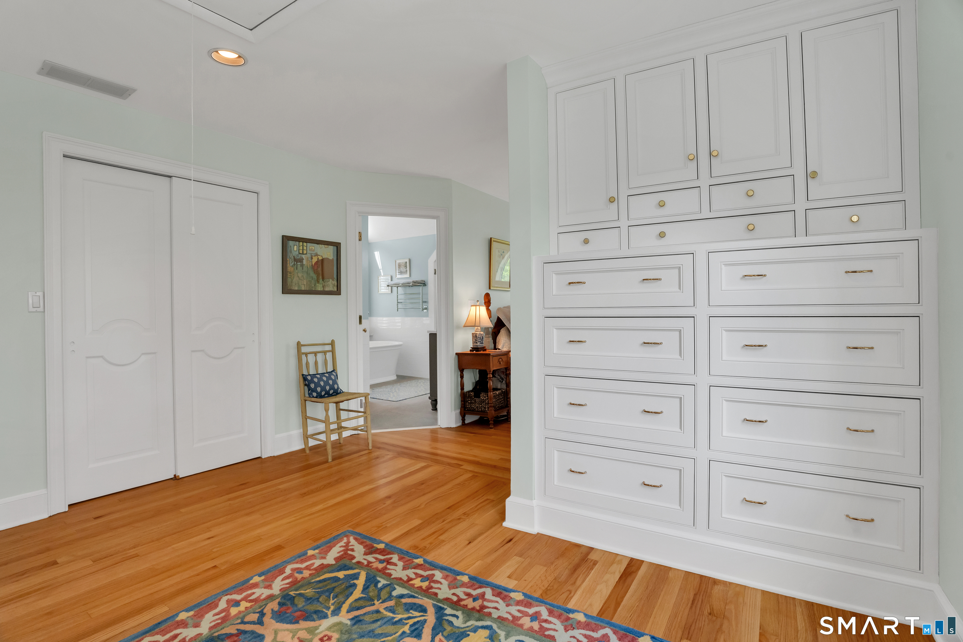 253-4 Grassy Hill Road Lyme, CT 06371 - Photo 23 of 40 a wall of built-in drawers and cabinets in bedroom dressing area