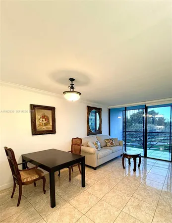 a bedroom with furniture and a large window