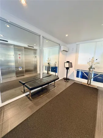 a lobby with a table and chairs