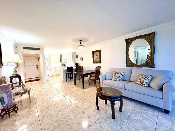 a living room with furniture a clock and a large mirror