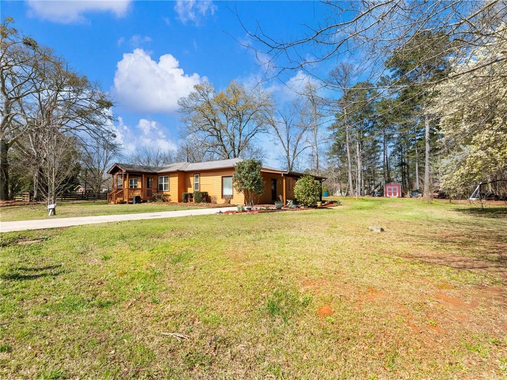 1686 Shoal Creek Road Monroe, GA 30656 - Photo 29 of 50 a swimming pool with outdoor seating and yard