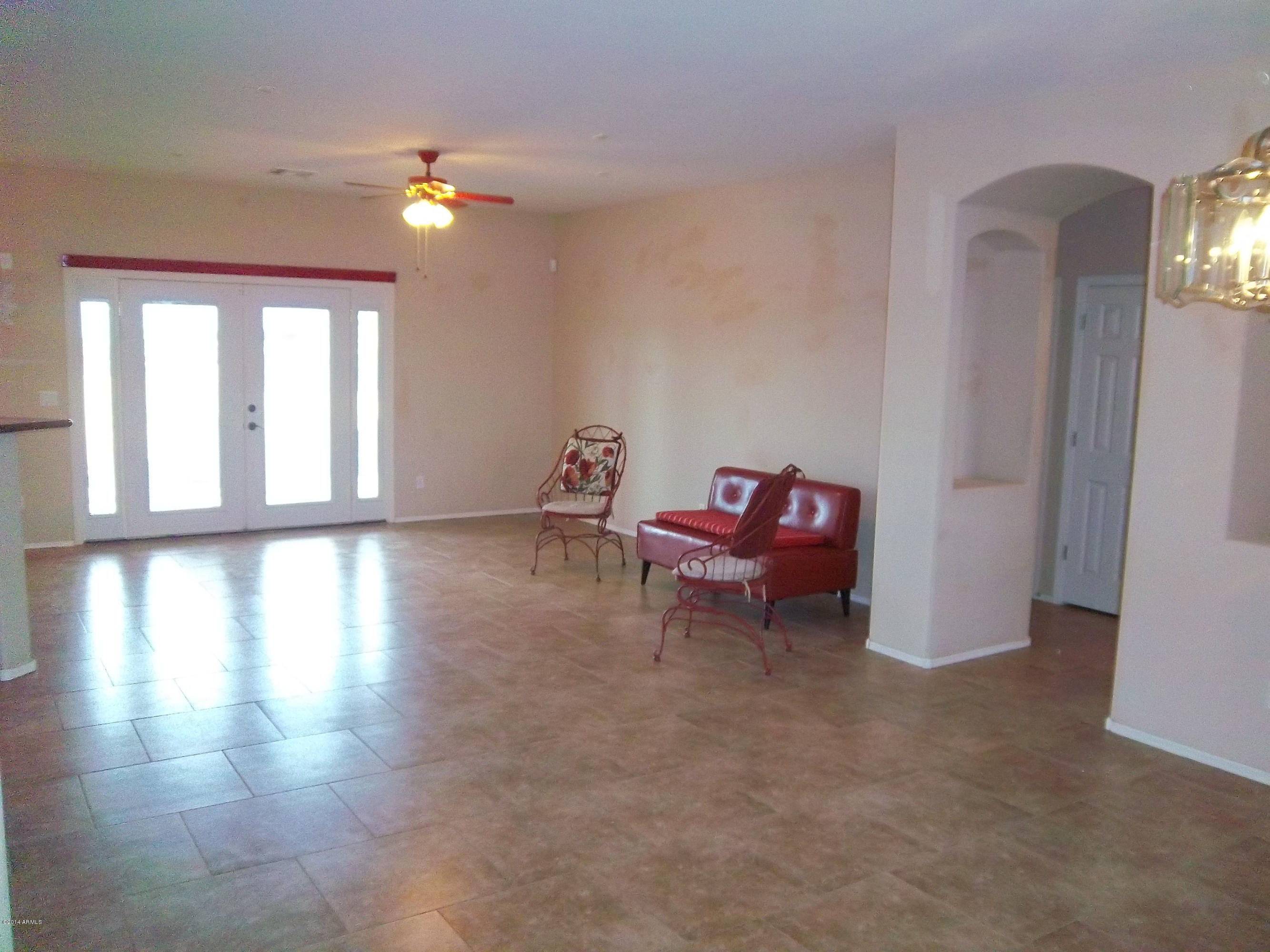 21117 West Steedridge Road Wittmann, AZ 85361 - Photo 4 of 66 Great room with large tiles