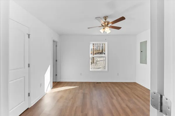 wooden floor in an empty room with a window