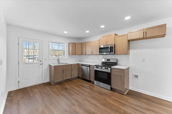 a kitchen with granite countertop a sink and steel stainless steel appliances