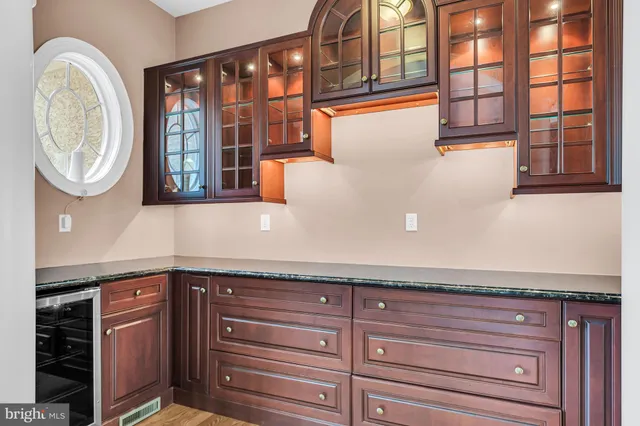 a kitchen with stainless steel appliances granite countertop a stove and a wooden floors