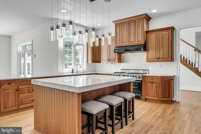 a kitchen with stainless steel appliances a stove a sink and a microwave