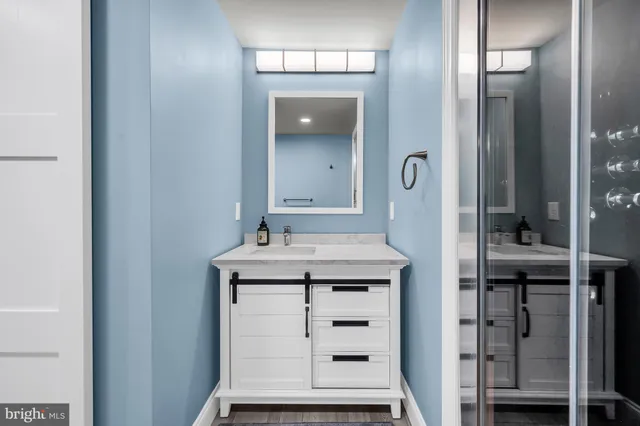 a spacious bathroom with a tub sink and mirror