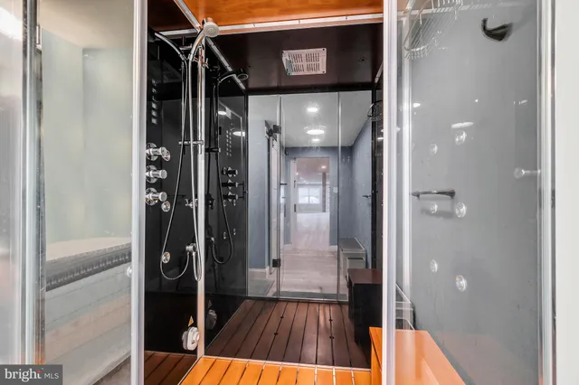 a spacious bathroom with a granite countertop sink mirror and shower