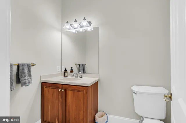 a utility room with stainless steel appliances white cabinets and a sink