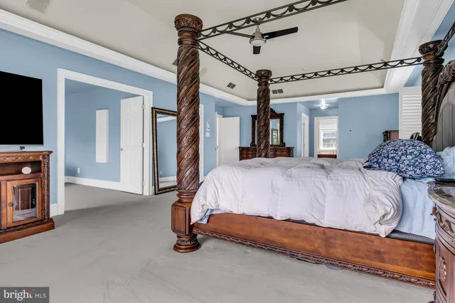 a spacious bedroom with a bed and a window