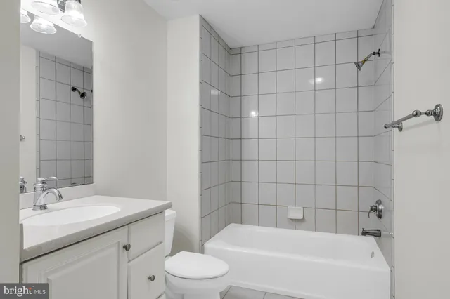 a large white building with swimming pool in front of it