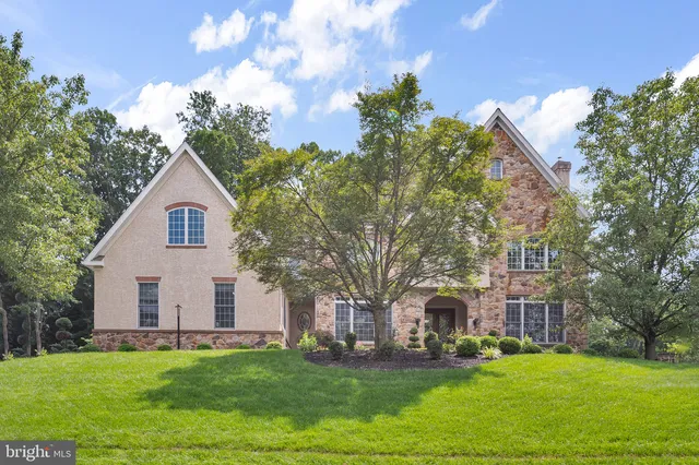 a front view of a house with potted plants