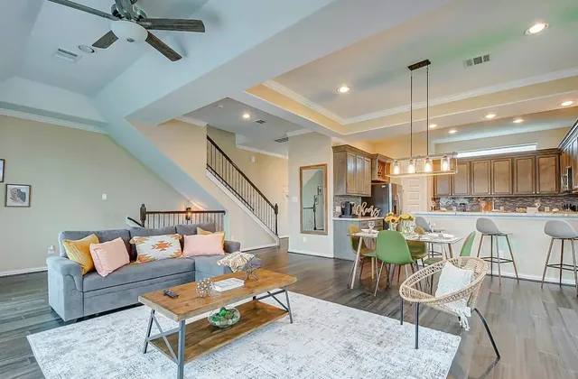 a living room with furniture and kitchen view