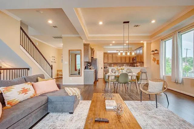 a living room with furniture and wooden floor