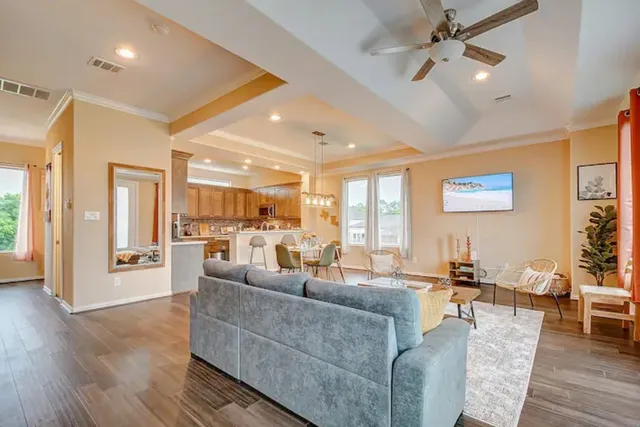 a living room with furniture and wooden floor
