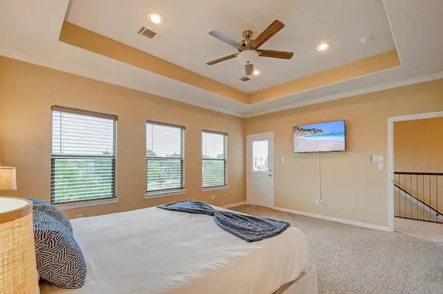 a bedroom with a bed and a large window