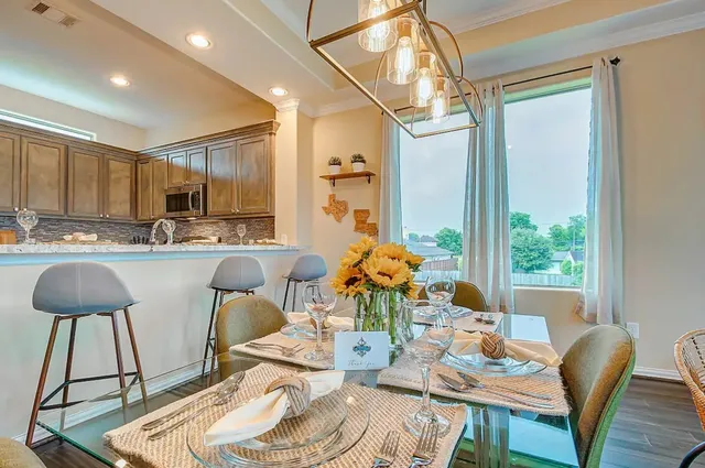 a living room with stainless steel appliances kitchen island granite countertop furniture and a large window