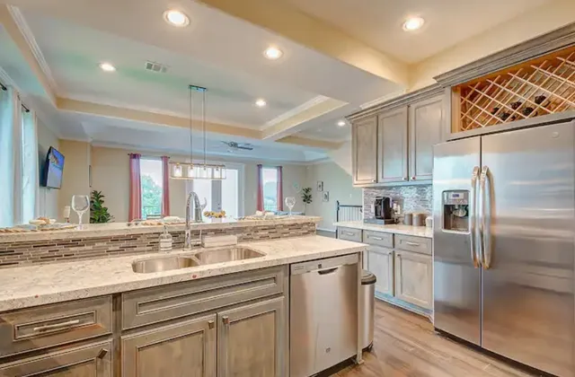 a kitchen with granite countertop a sink stainless steel appliances and cabinets