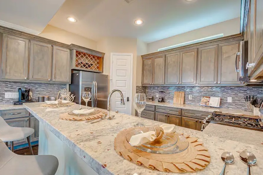 3909 Griggs Road Houston, TX 77021 - Photo 6 of 26 a kitchen with stainless steel appliances kitchen island granite countertop a sink and cabinets