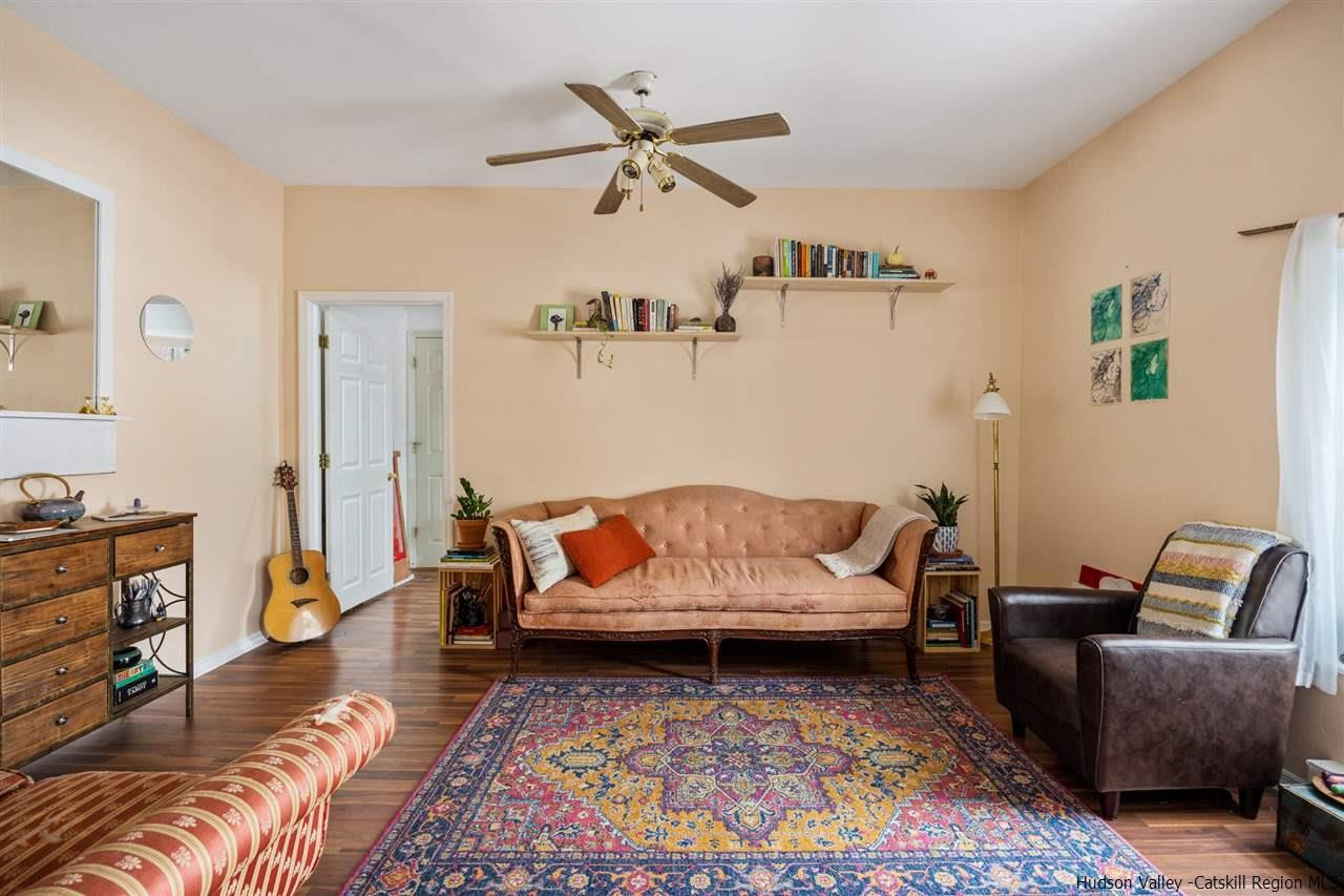 744-746 Broadway Kingston, NY 12401 - Photo 14 of 28 a living room with furniture ceiling fan and a rug