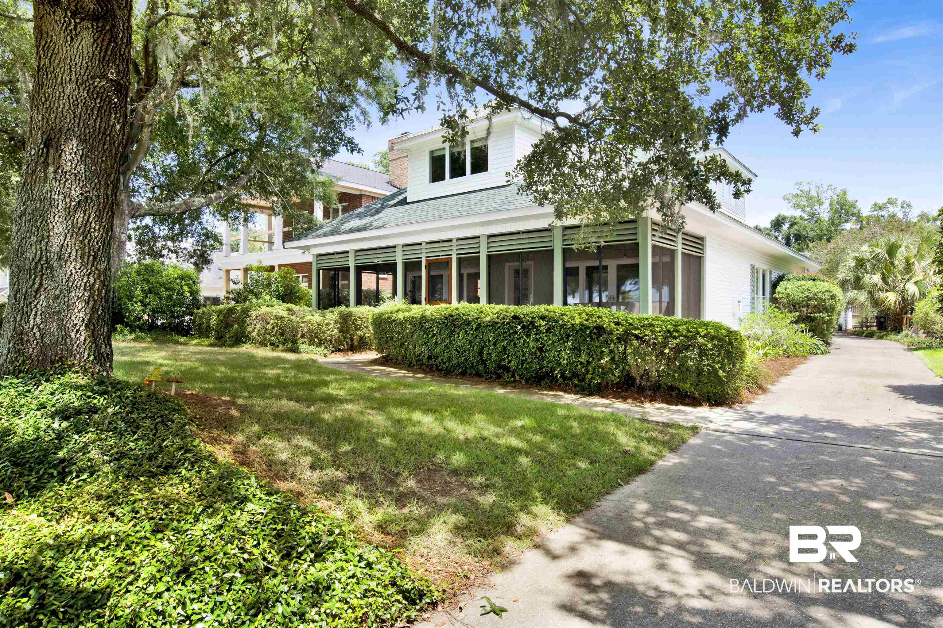 409 South Mobile Street Fairhope, AL 36532 - Photo 2 of 48 View of front of property featuring a front yard and roof with shingles
