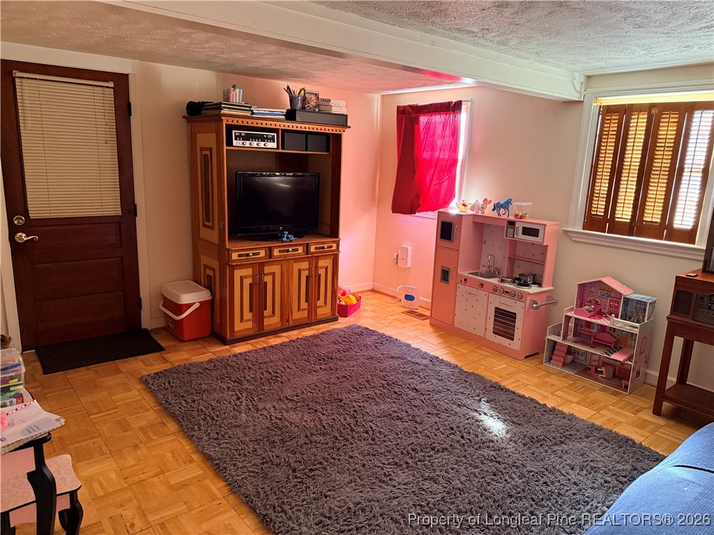 655 Wiltshire Road Fayetteville, NC 28314 - Photo 14 of 17 a living room with furniture and a flat screen tv