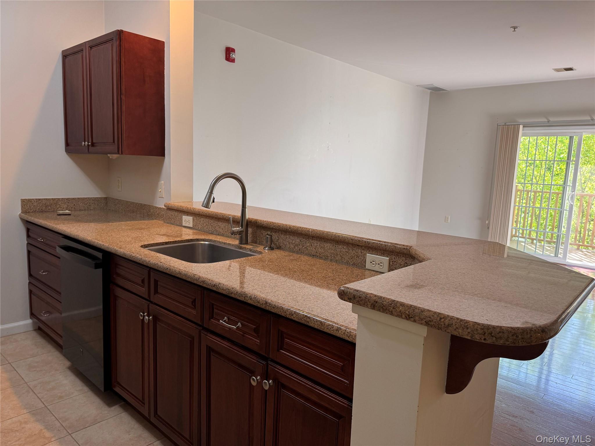935 Tower Ridge Circle Middletown, NY 10941 - Photo 14 of 23 a kitchen with a sink cabinets and a wooden floor
