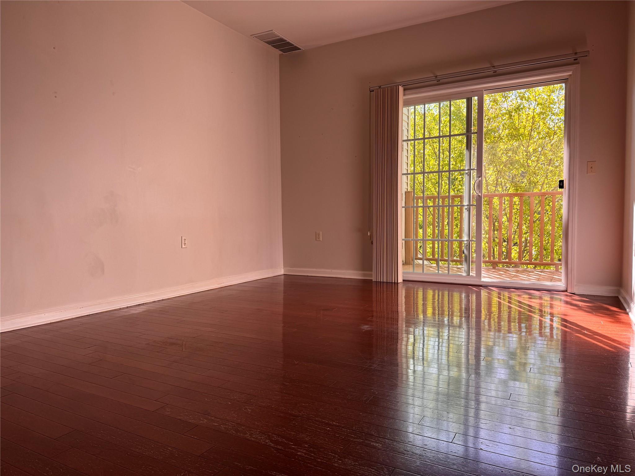 935 Tower Ridge Circle Middletown, NY 10941 - Photo 21 of 23 a view of an empty room with wooden floor and a window