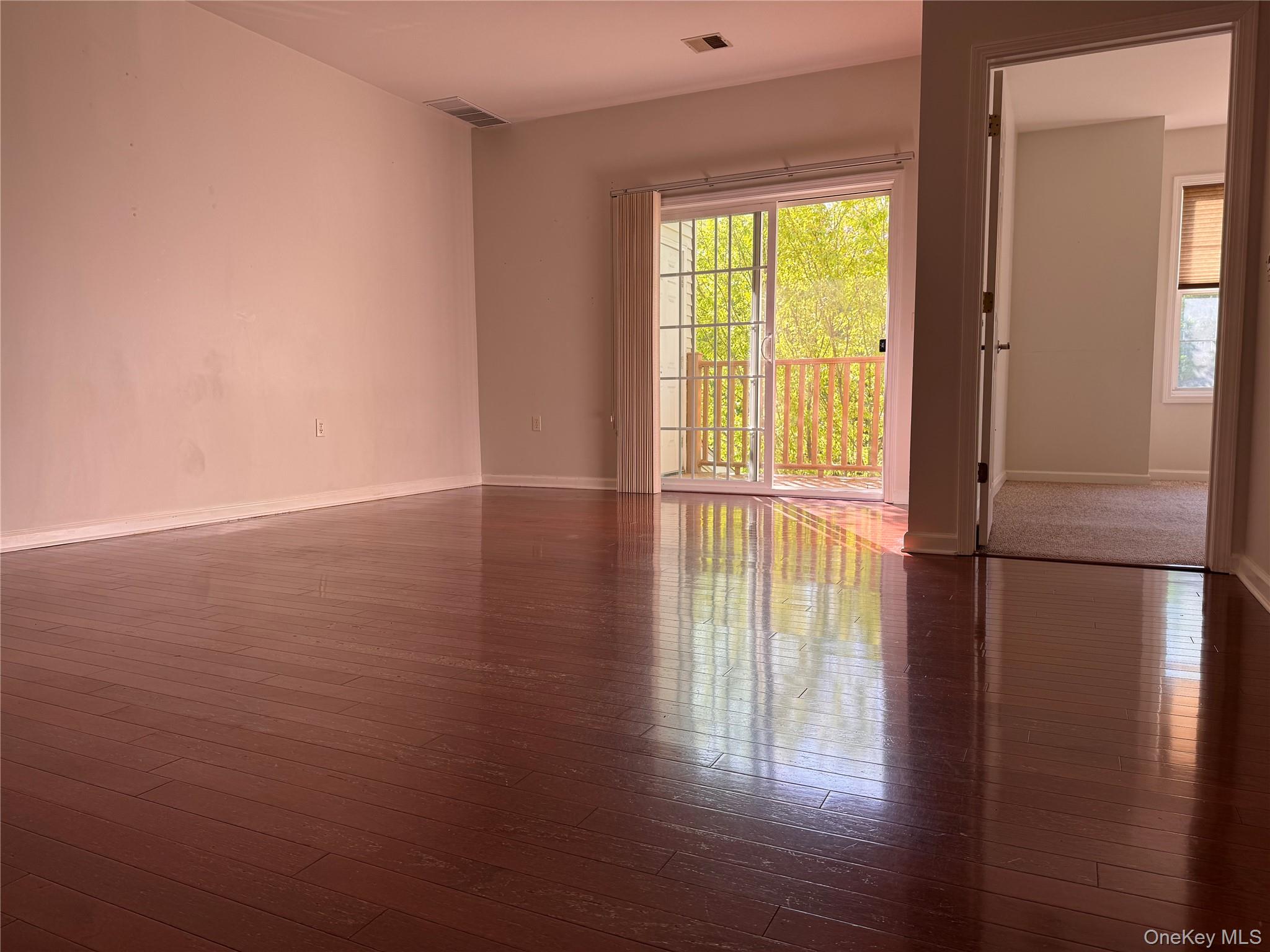 935 Tower Ridge Circle Middletown, NY 10941 - Photo 22 of 23 a view of an empty room with wooden floor and a window