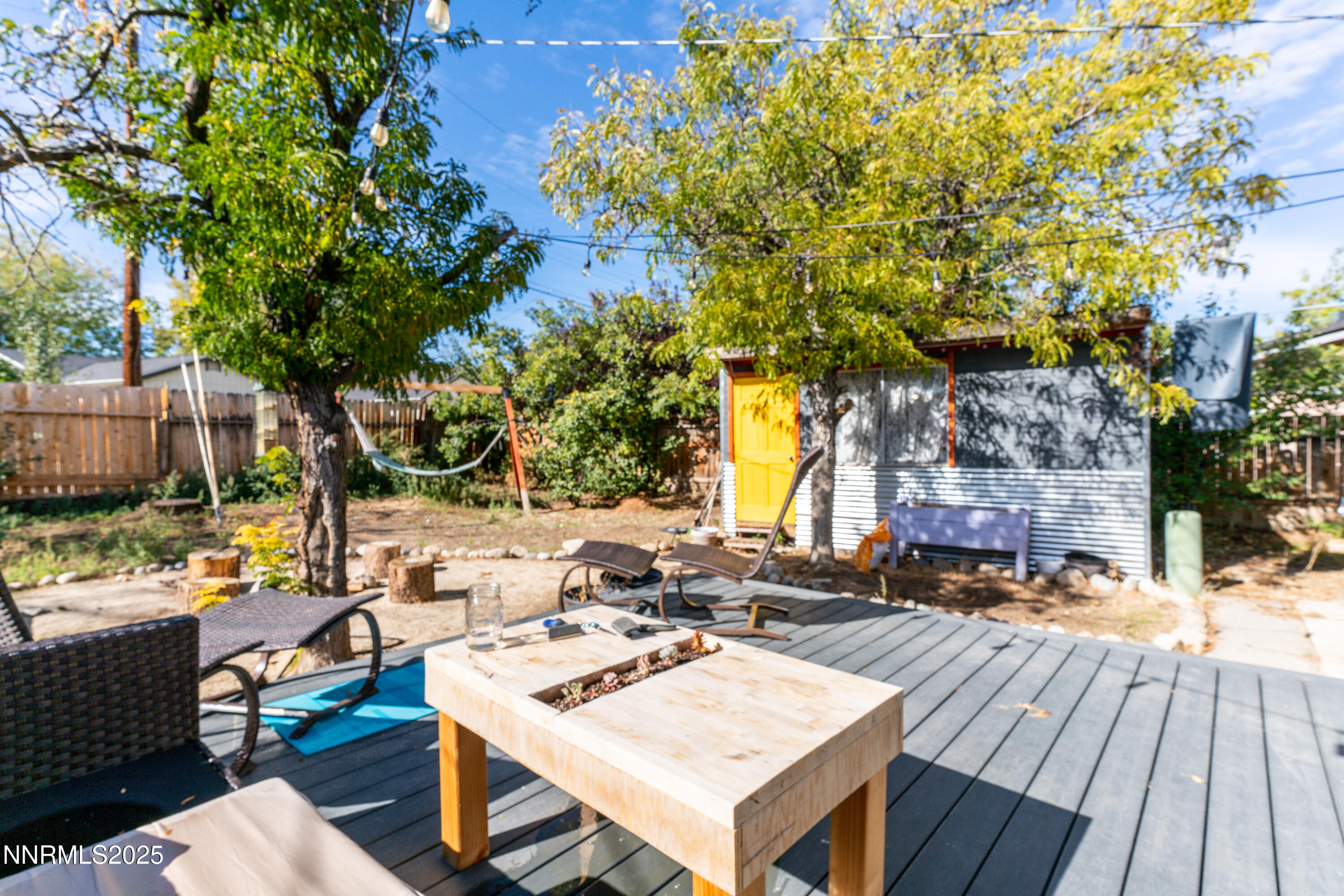 995 Beldon Way Reno, NV 89503 - Photo 16 of 17 a view of a patio with table and chairs and potted plants with wooden floor and fence