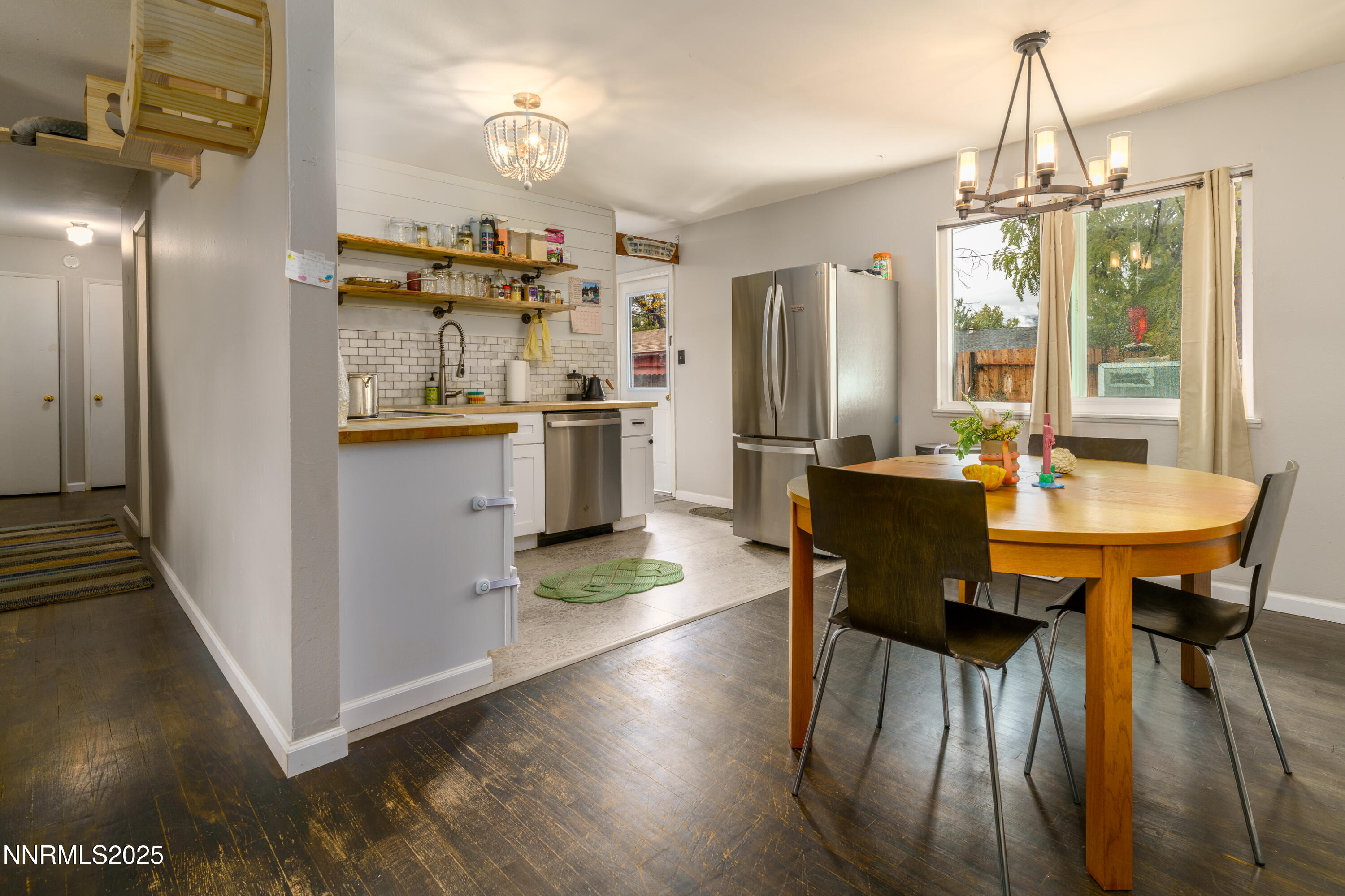 995 Beldon Way Reno, NV 89503 - Photo 6 of 17 a kitchen with stainless steel appliances a dining table chairs and chandelier