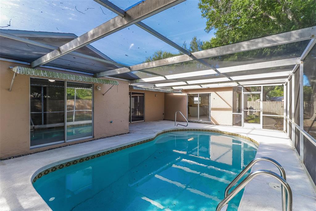 12907 Cedar Ridge Drive Hudson, FL 34669 - Photo 19 of 21 a view of a house with pool fire pit and outdoor seating
