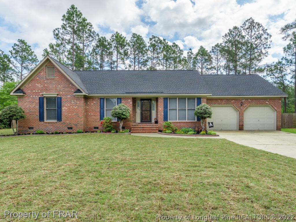 7790 Dragonhead Road Fayetteville, NC 28311 - Photo 1 of 36 a front view of a house with a garden and porch