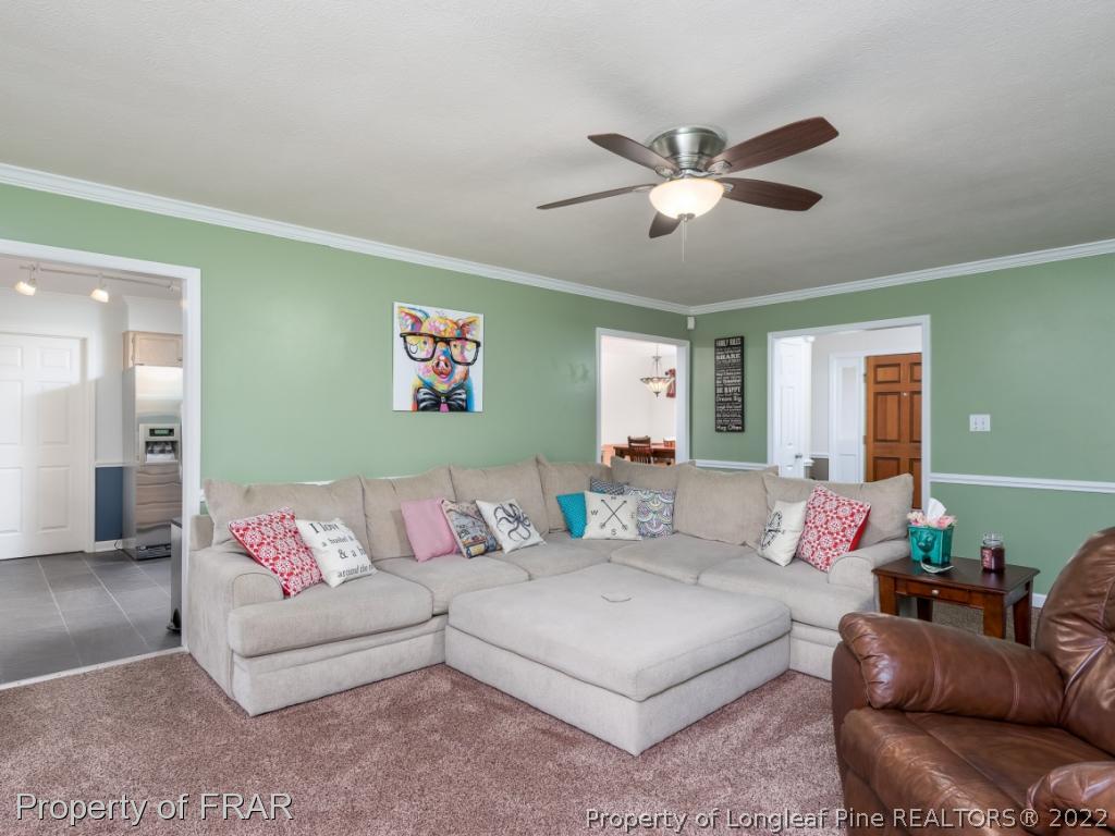 7790 Dragonhead Road Fayetteville, NC 28311 - Photo 13 of 36 a living room with furniture and a ceiling fan