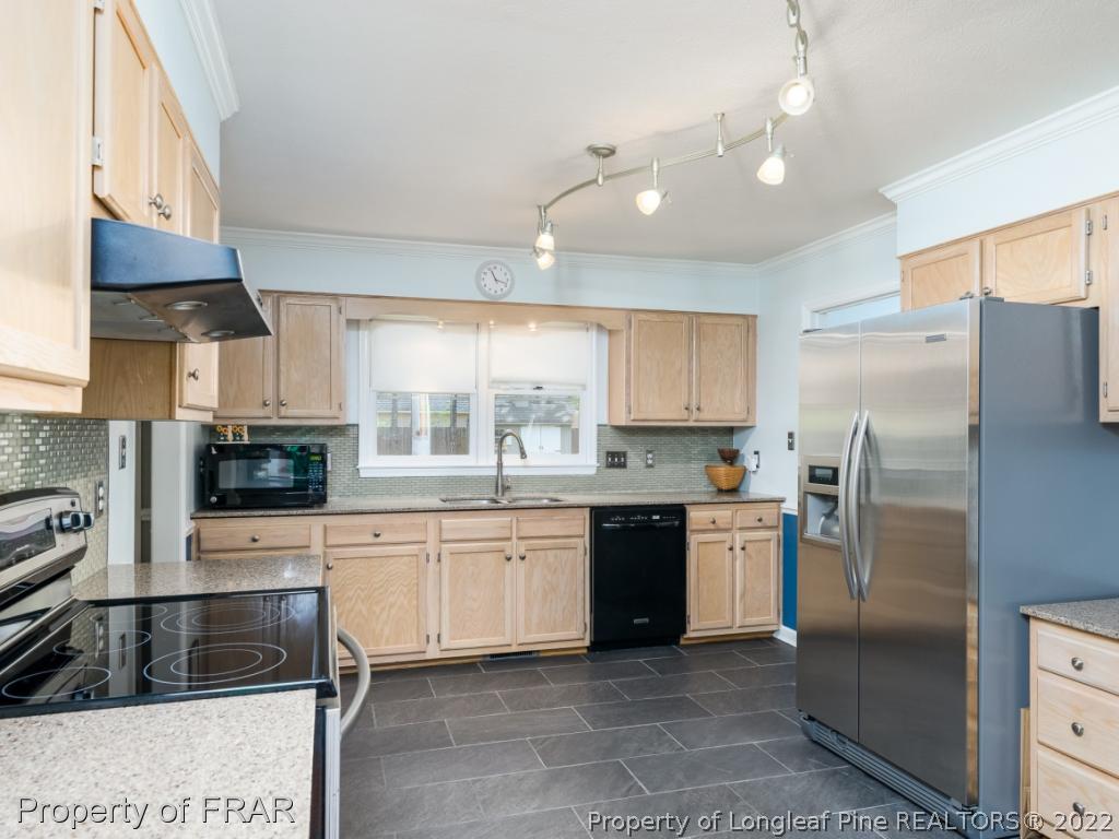 7790 Dragonhead Road Fayetteville, NC 28311 - Photo 16 of 36 a kitchen with a sink stove and refrigerator